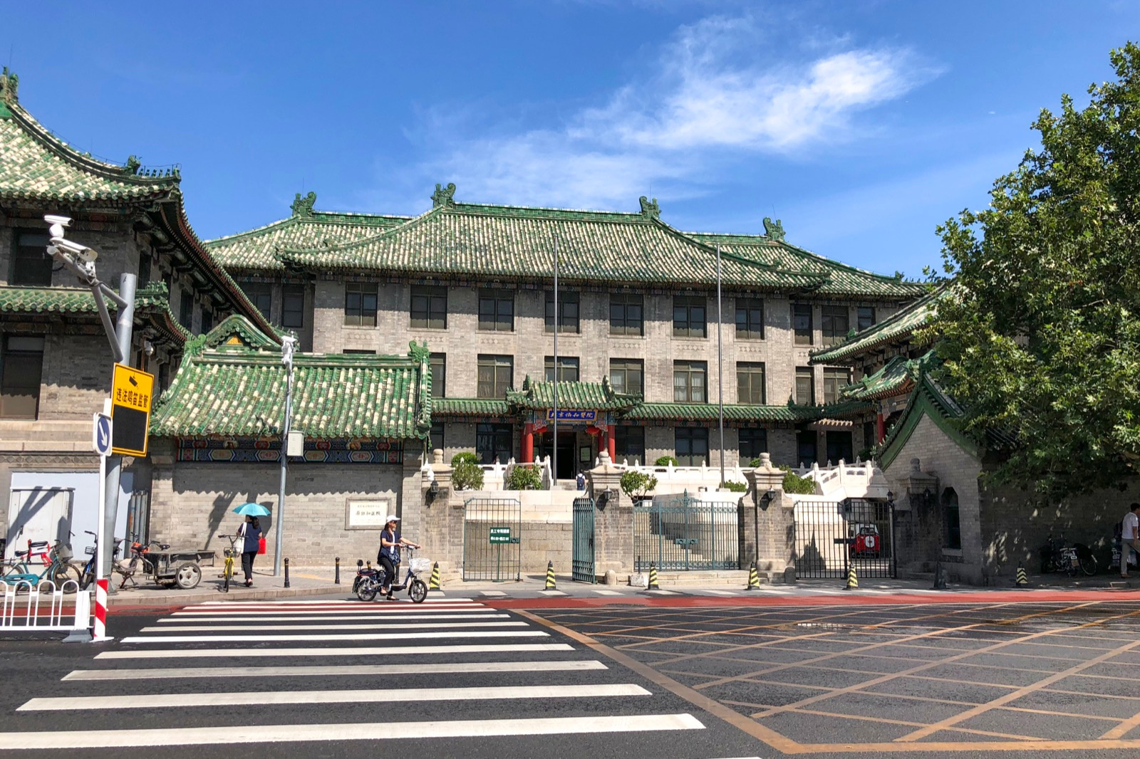Historic grey-brick building of Peking Union Medical College Hospital with green tiled Chinese roofs