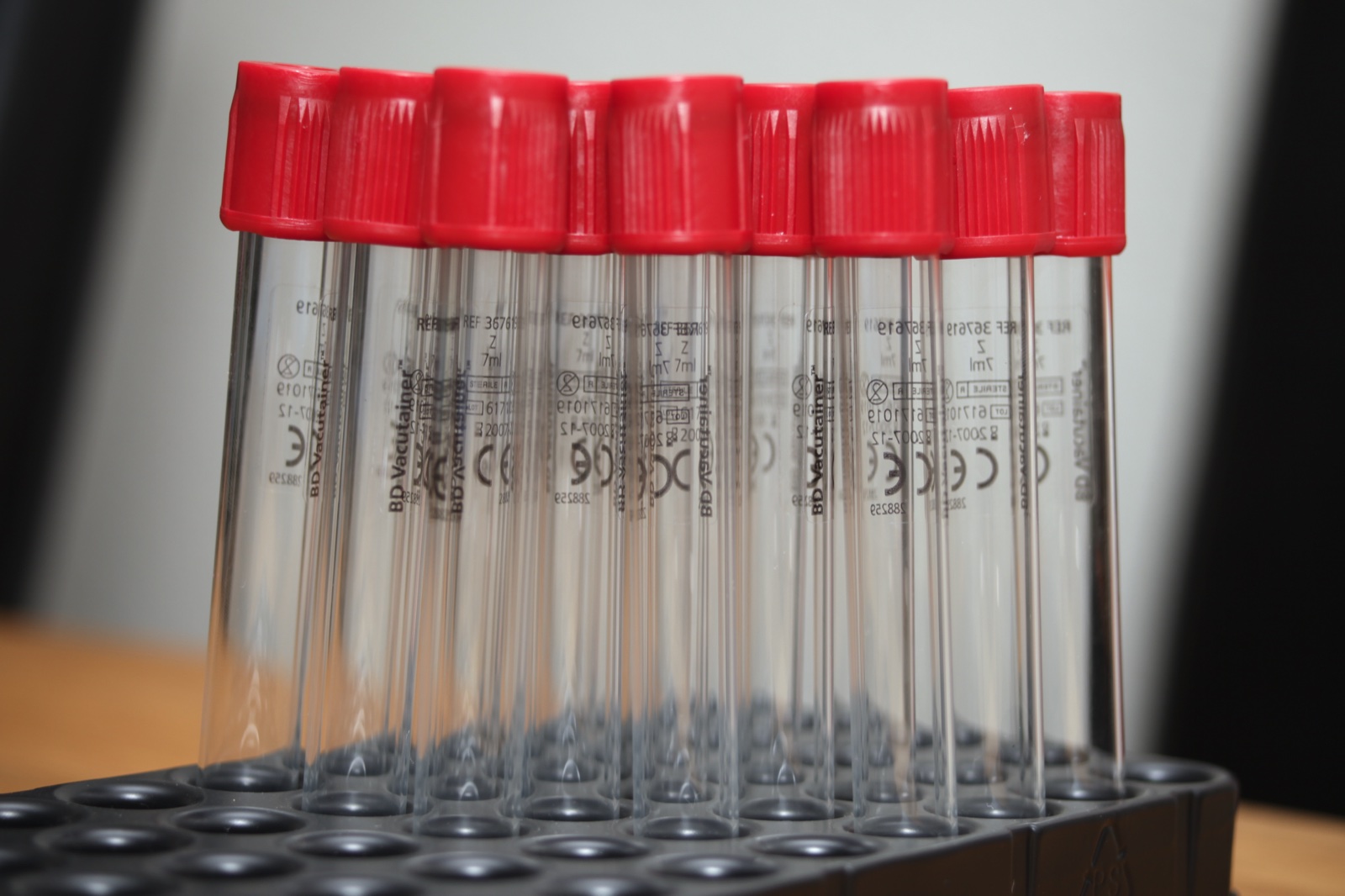 Rack of vacuum blood collection tubes with red caps