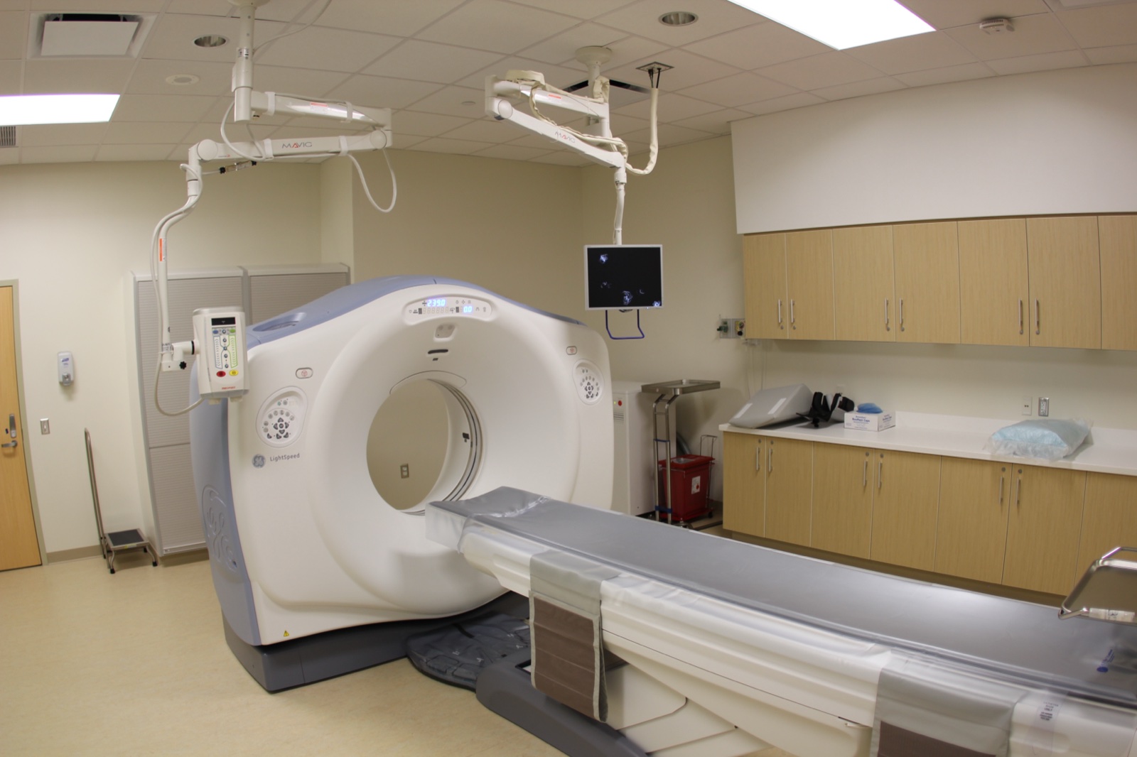 Empty hospital room with a CT scanner and examination table
